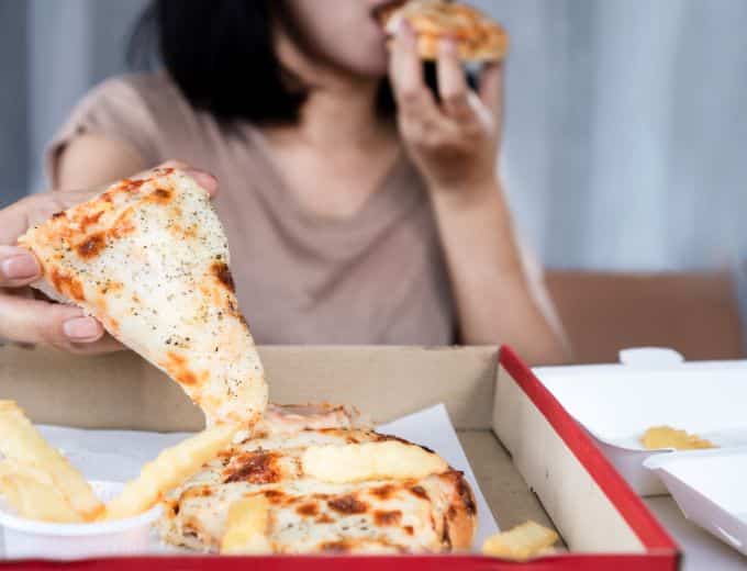 Woman eating pizza