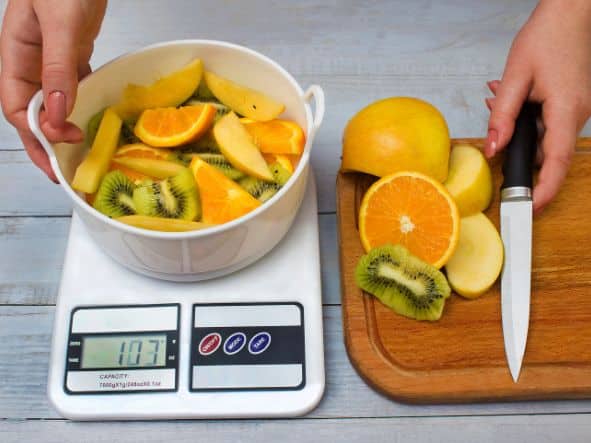 weighing fruit on food scale