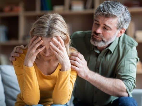 older man consoling upset woman